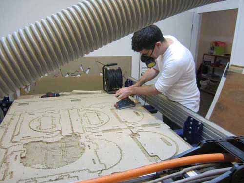 sanding the edges Sanding down the edges after the ShopBot has milled out the profiles